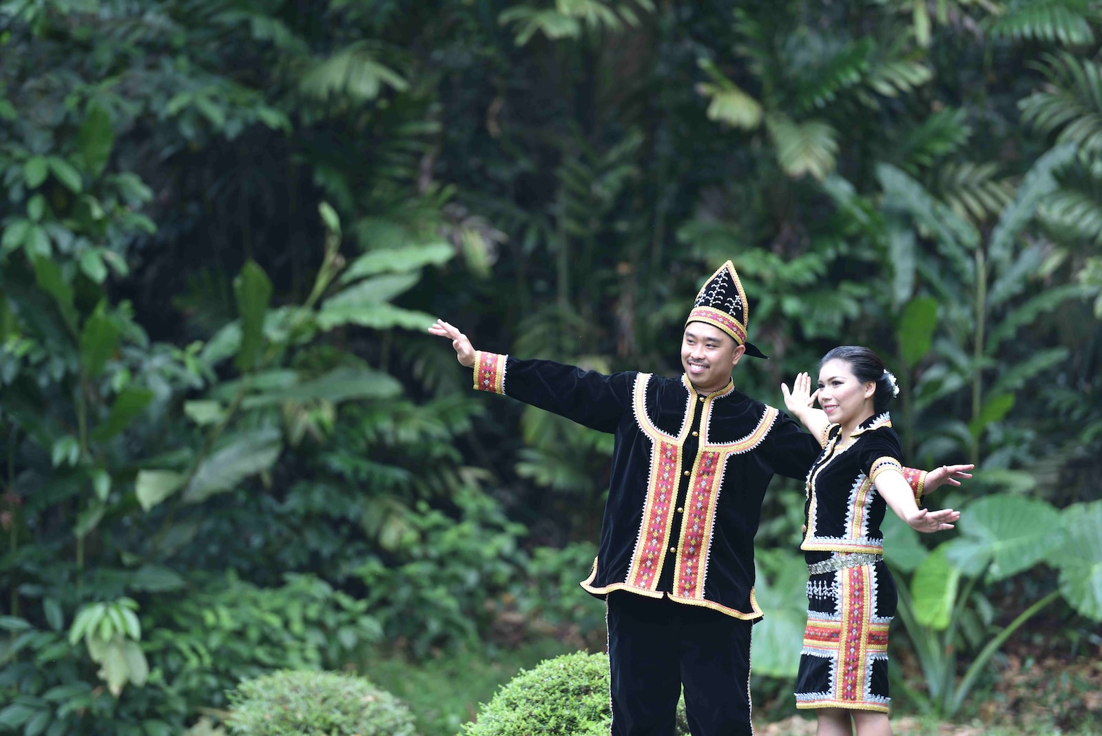 man and woman standing near trees