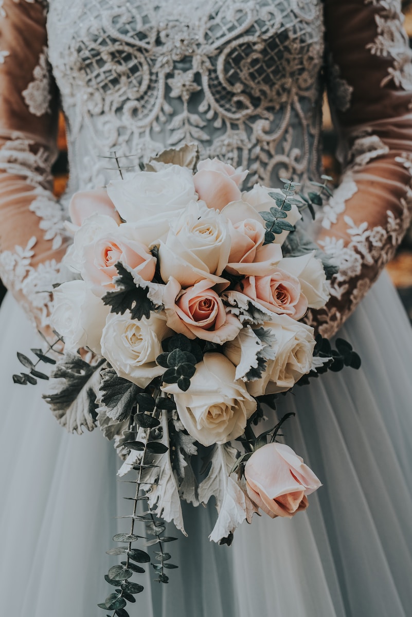 woman holding bouquet of roses