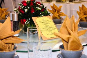 a table set with a menu and napkins