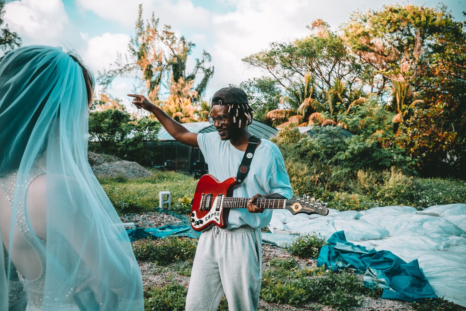 man in white shirt playing guitar